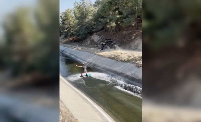 Sulama kanalında ATV ile sörf yaptı