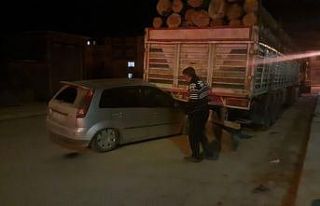 Otomobil park halindeki tırın altına girdi