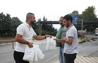 Servis bekleyen işçilere poğaça dağıtılıyor