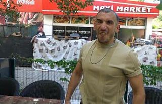 Müşterilerini kapıda havlayarak karşılayan garson,...